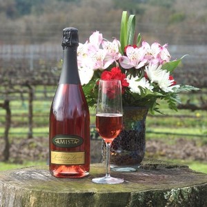 Sparkling Syrah from Amista Vineyards with Glass or Sparkling and Flowers in the Vineyard