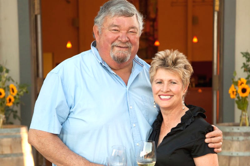 Amista Vineyards Proprietors, Mike and Vicky in front of tasting room