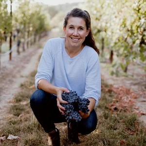 Winemaker Ashley Herzberg with Grapes at Amista Vineyards