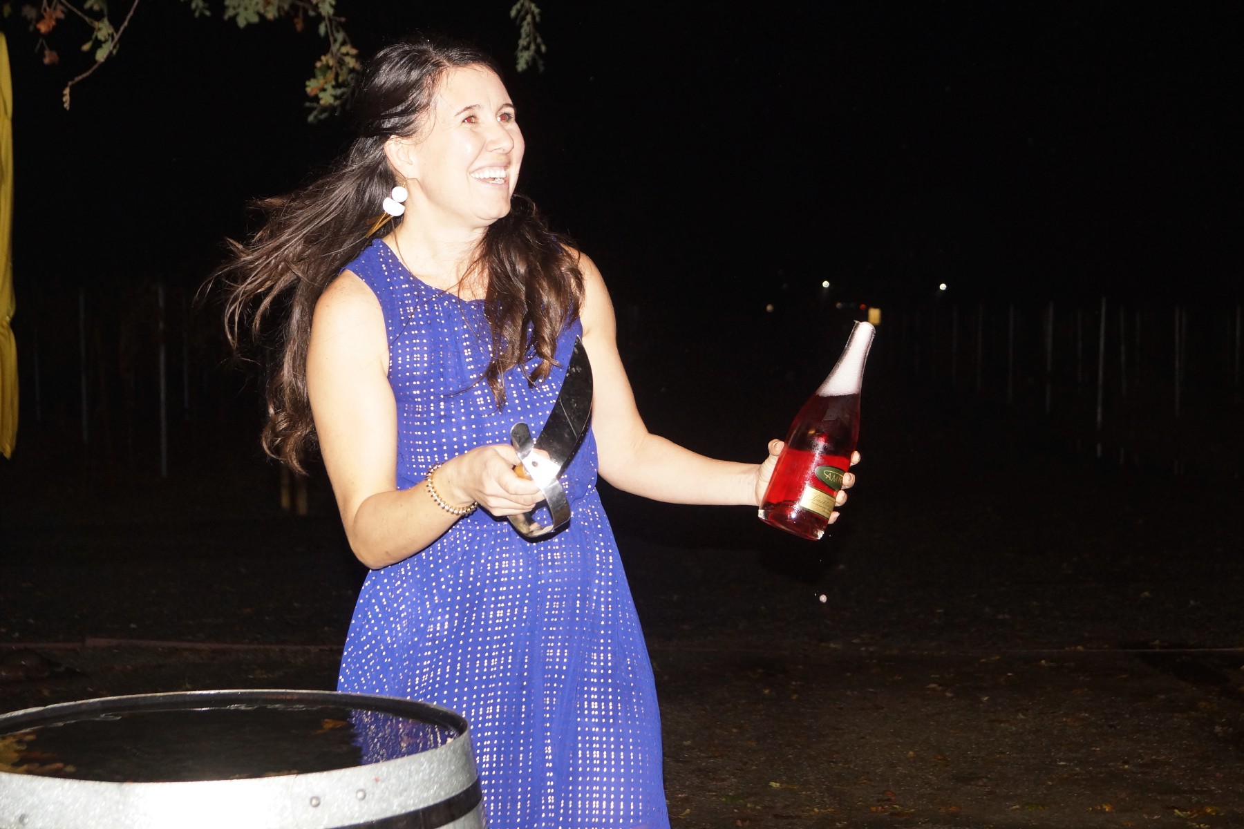 Winemaker Ashley Herzberg of Amista Vineyards Sabering Sparkling Syrah